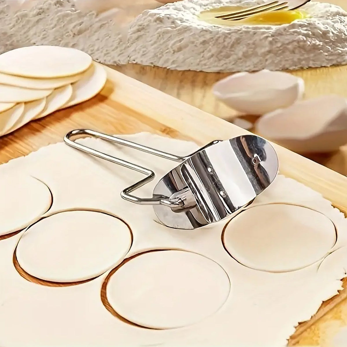 Stainless steel puri cutter roller with comfortable handle on a clean surface.