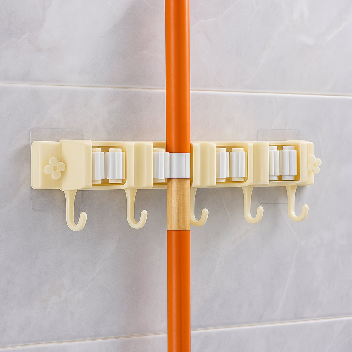 Close-up image of broom holder's multi-roller grip system on wall