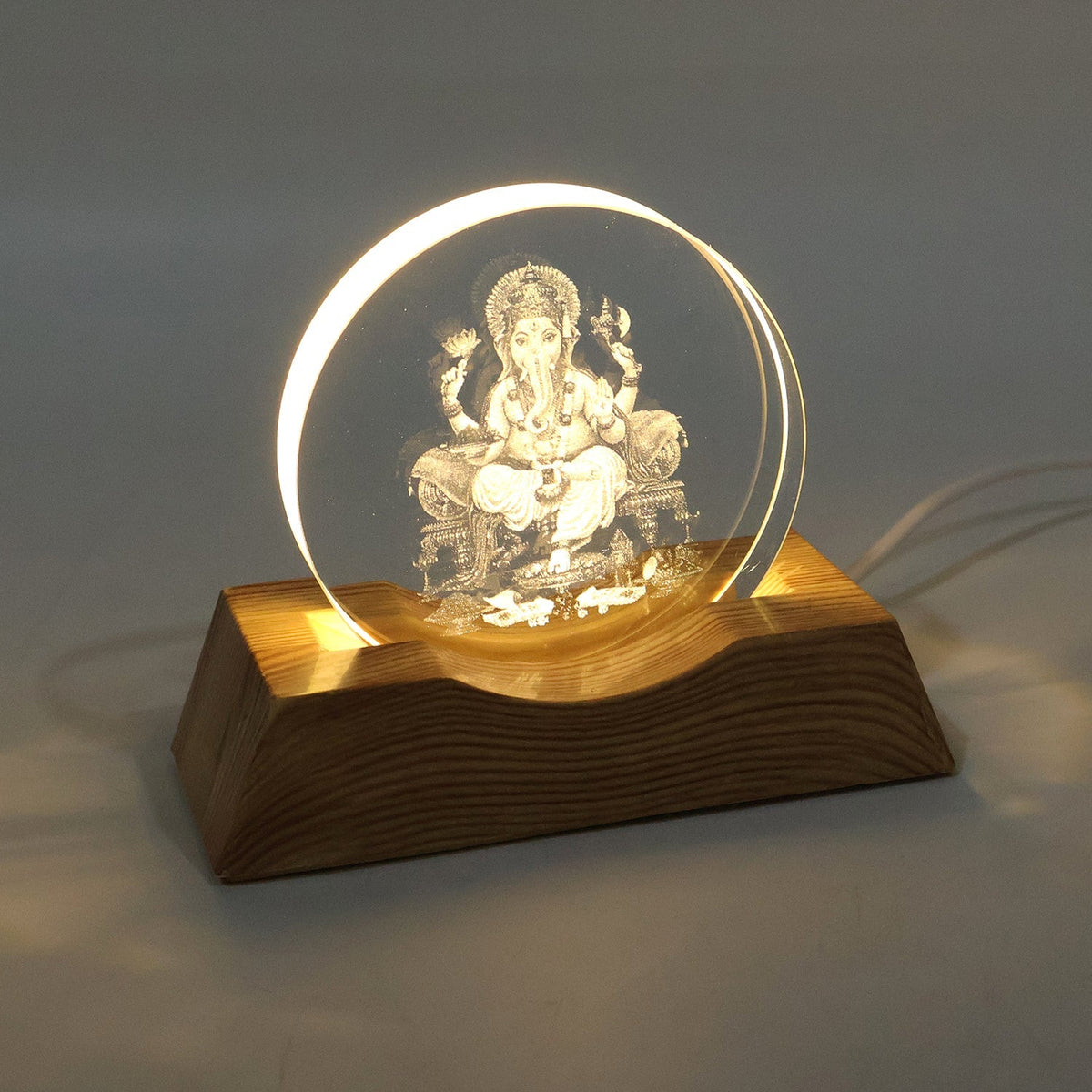 3D Lord Ganesha LED lamp emitting warm light in dim room