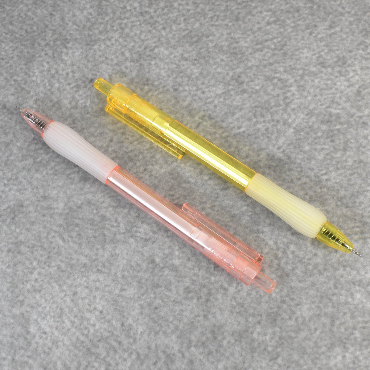 A pair of CustoPen ballpoint pens displayed with essential office stationery.
