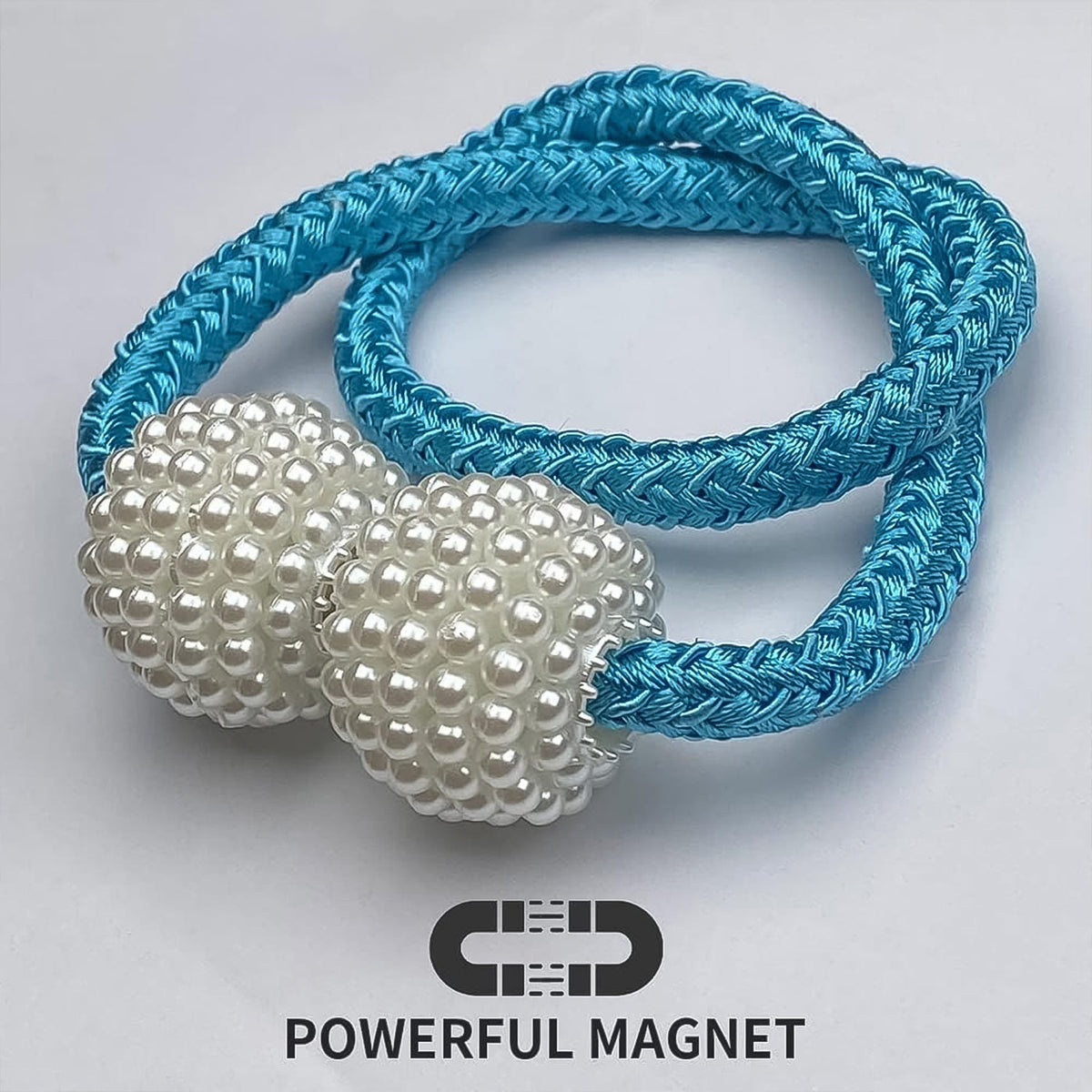 Hand holding magnetic curtain tieback demonstrating size and ease of use