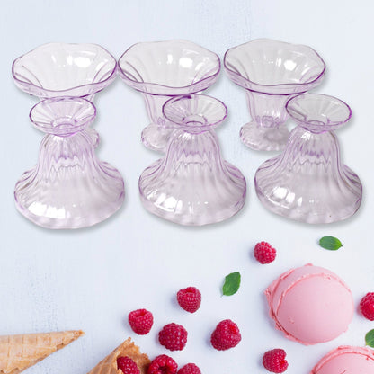Clear plastic serving bowls displayed with various fruits and snacks.