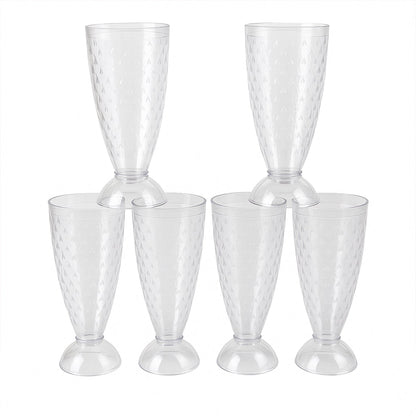 Transparent plastic milkshake glasses neatly arranged on a dining table