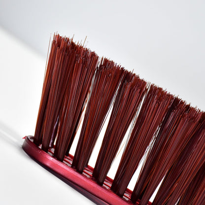 Velvet Wipe duster brush gently removing dust from a car dashboard.