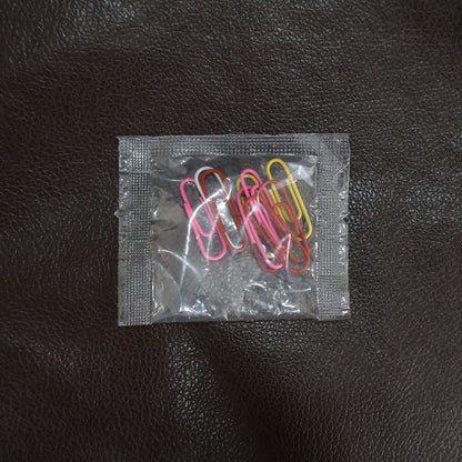 Colourful vinyl-coated paper clips securely holding important files and documents together.