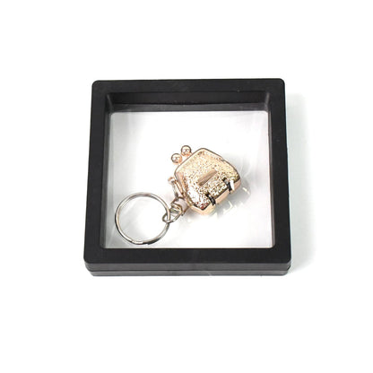 Mini nail clipper keychain in clear showcase with 3D floating effect