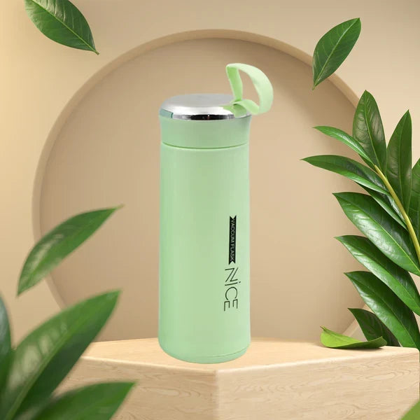 Close-up of glass water bottle 400ml leakproof bamboo lid in light green