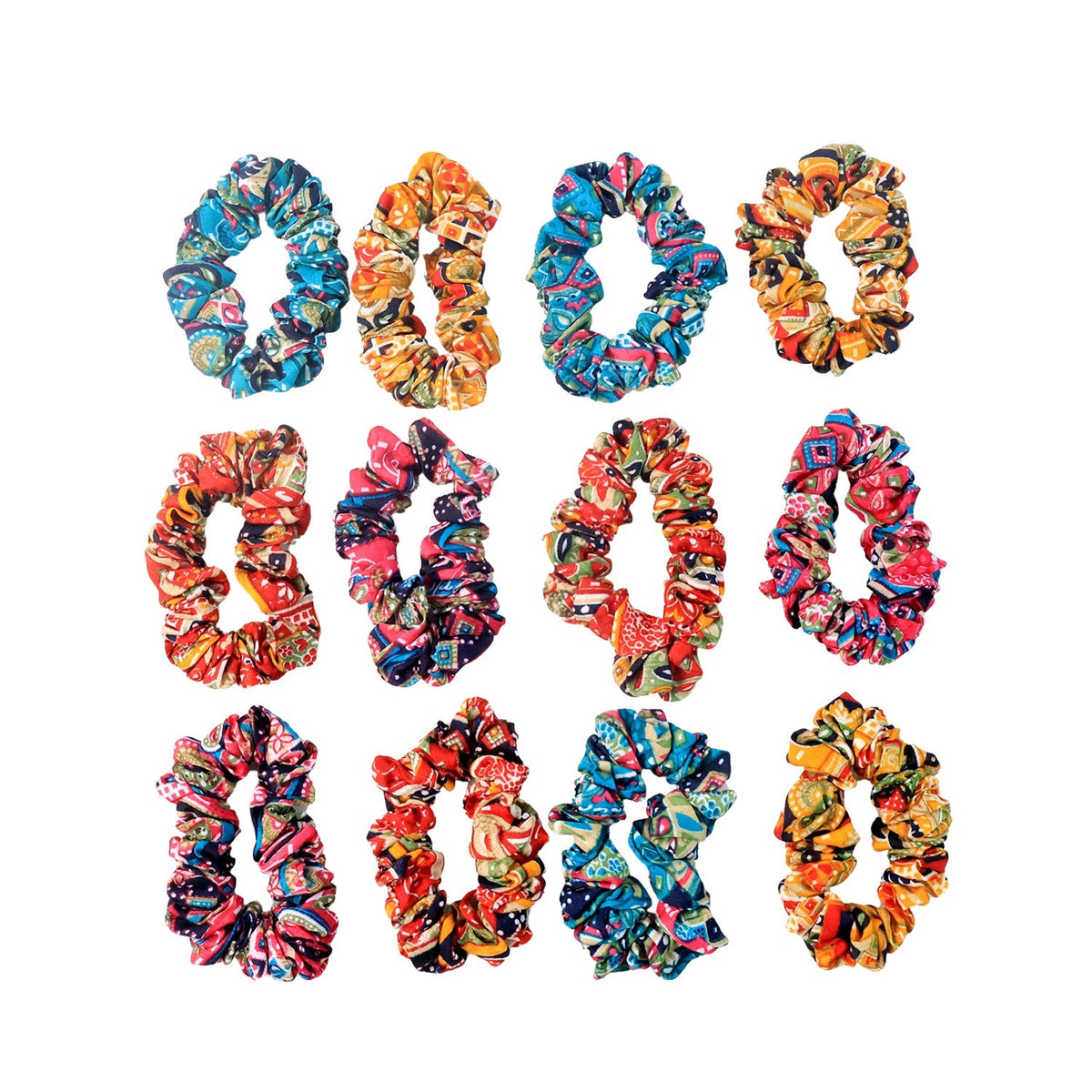 Displayed set of 12 printed fabric hair scrunchies on a flat surface