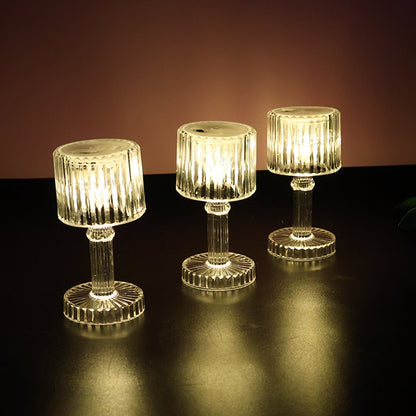Multiple LED crystal-effect lamps arranged on table for festive decor
