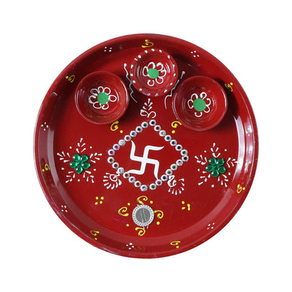 Three diyas arranged on vibrant hand-painted pooja thali for festivals
