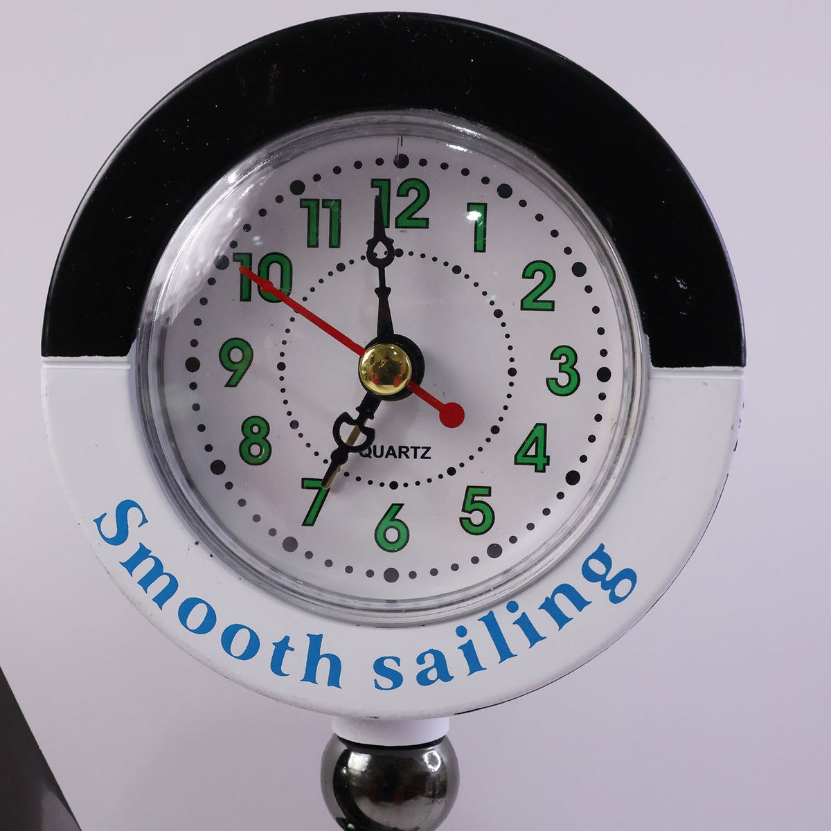 Ship shape clock lamp lit on table showing warm LED ambiance